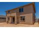 Rear exterior view of the home showcasing the backyard, patio, and stucco finish at 18351 W Patrick Ln, Surprise, AZ 85387