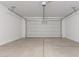 Clean and spacious garage showcasing the door and concrete flooring at 18351 W Patrick Ln, Surprise, AZ 85387