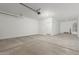 Spacious garage with ample room for parking and storage, featuring painted walls at 18351 W Patrick Ln, Surprise, AZ 85387