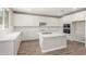 Spacious kitchen with large island, white cabinets, and stainless steel appliances at 18351 W Patrick Ln, Surprise, AZ 85387