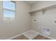 Bright laundry room featuring neutral paint, window and washer/dryer hookups at 18351 W Patrick Ln, Surprise, AZ 85387
