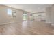 Spacious living room featuring hard wood floors, large windows and open to kitchen area at 18351 W Patrick Ln, Surprise, AZ 85387