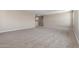 Spacious living room featuring neutral paint, plush carpet, and plenty of natural light at 18351 W Patrick Ln, Surprise, AZ 85387