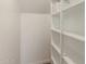 Walk in pantry featuring white shelves for optimal storage at 18351 W Patrick Ln, Surprise, AZ 85387