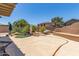 Inviting backyard with a rock pool feature, mature landscaping, and cozy seating areas for relaxation and entertainment at 18449 W Piedmont Rd, Goodyear, AZ 85338