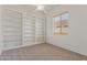 Bright bedroom featuring carpet floors, a window, and built-in bookcase at 18449 W Piedmont Rd, Goodyear, AZ 85338