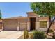Beautiful home featuring a three-car garage, desert landscaping, and a covered entryway at 18449 W Piedmont Rd, Goodyear, AZ 85338