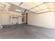 Spacious garage with concrete flooring, a well-lit area, and ample storage space for vehicles and equipment at 18449 W Piedmont Rd, Goodyear, AZ 85338