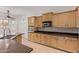 Well-appointed kitchen with stainless steel appliances, ample counter space, and wood cabinets at 18449 W Piedmont Rd, Goodyear, AZ 85338