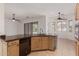 Kitchen featuring wood cabinets and a view into the living room at 18449 W Piedmont Rd, Goodyear, AZ 85338