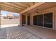 Charming covered patio with lattice detail, providing shade and access to the landscaped backyard oasis at 18449 W Piedmont Rd, Goodyear, AZ 85338