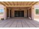 Inviting covered patio with decorative lattice, ceiling fan, and access to the backyard for outdoor living at 18449 W Piedmont Rd, Goodyear, AZ 85338