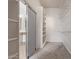 Walk-in closet space with shelving and sliding door to bathroom at 18449 W Piedmont Rd, Goodyear, AZ 85338