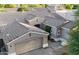 Aerial view of a home showcasing a well-maintained roof, a two-car garage, and manicured landscaping at 1865 E Locust Pl, Chandler, AZ 85286