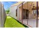 Backyard featuring artificial grass, a built-in putting green, and a covered patio with stylish string lights at 1865 E Locust Pl, Chandler, AZ 85286