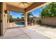Inviting covered patio overlooking a refreshing pool area with lush landscaping and secure fencing at 1865 E Locust Pl, Chandler, AZ 85286