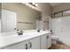 A bright bathroom with double sinks, a large mirror, and a shower-tub combination at 1865 E Locust Pl, Chandler, AZ 85286