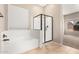 A bathroom with a tub and a glass-enclosed shower offers a clean and relaxing space at 1865 E Locust Pl, Chandler, AZ 85286