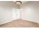 A bedroom with neutral walls and carpet, complemented by a large closet with white doors at 1865 E Locust Pl, Chandler, AZ 85286