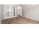 Bedroom with light-colored walls, carpet and open glass doors to other rooms at 1865 E Locust Pl, Chandler, AZ 85286