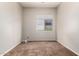 A cozy bedroom with neutral walls and carpet, featuring a window providing natural light at 1865 E Locust Pl, Chandler, AZ 85286