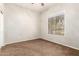 Cozy bedroom with neutral walls, carpet, and a large window offering a pleasant view at 1865 E Locust Pl, Chandler, AZ 85286