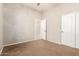 A bedroom with neutral walls and carpet and a sliding closet with white doors at 1865 E Locust Pl, Chandler, AZ 85286
