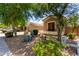 Attractive home exterior with desert landscaping, mature trees, and a well-kept lawn at 1865 E Locust Pl, Chandler, AZ 85286