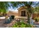 Inviting front yard with desert landscaping and mature trees, showcasing the charming exterior of this lovely home at 1865 E Locust Pl, Chandler, AZ 85286