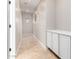 A well-lit hallway features tiled floors and built-in storage cabinets, ideal for organizing household items at 1865 E Locust Pl, Chandler, AZ 85286