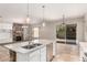 Open concept kitchen with a granite island, stainless steel appliances, and views of the Gathering room at 1865 E Locust Pl, Chandler, AZ 85286
