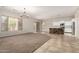 Spacious living area featuring neutral colors and tile flooring, with a kitchen and backyard access at 1865 E Locust Pl, Chandler, AZ 85286