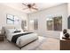 A furnished primary bedroom features neutral tones, two windows, and stylish decor for a cozy retreat at 1865 E Locust Pl, Chandler, AZ 85286