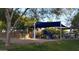 Community playground featuring a shaded play structure, swing set, and picnic area surrounded by mature trees at 1865 E Locust Pl, Chandler, AZ 85286