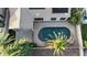 Aerial view of a private backyard featuring a dark blue swimming pool, covered patio, and lush landscaping at 1865 E Locust Pl, Chandler, AZ 85286