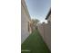 The side yard between homes has artificial turf for low-maintenance landscaping at 1865 E Locust Pl, Chandler, AZ 85286