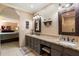Elegant bathroom with dual sink vanity, granite countertops, and decorative mirrors at 18780 N 94Th Ave, Peoria, AZ 85382