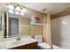 Well-lit bathroom featuring a vanity, toilet, and a shower with tile surround at 18780 N 94Th Ave, Peoria, AZ 85382