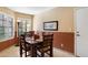 Well-lit dining area with wainscoting, stylish furnishings, and shuttered windows at 18780 N 94Th Ave, Peoria, AZ 85382