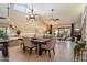 Bright and airy dining area featuring tile floors, a chandelier, and views of the living space at 18780 N 94Th Ave, Peoria, AZ 85382