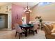 Cozy dining space with tile floors, chandelier lighting, and a view into the kitchen at 18780 N 94Th Ave, Peoria, AZ 85382