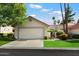 Charming single-story home with a two-car garage, well-maintained lawn, and attractive landscaping at 18780 N 94Th Ave, Peoria, AZ 85382