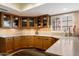 Charming kitchen featuring wood cabinets, light countertops, and stainless steel sink at 18780 N 94Th Ave, Peoria, AZ 85382