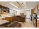 Bright kitchen features a skylight, stainless steel appliances, wood cabinets and light countertops at 18780 N 94Th Ave, Peoria, AZ 85382