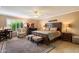 Spacious bedroom with ceiling fan, desk, sitting chair, and large bed at 18780 N 94Th Ave, Peoria, AZ 85382