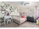 Spacious bedroom with floral wallpaper, ceiling fan, and cozy décor at 20038 N 38Th Ln, Glendale, AZ 85308