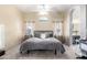 Comfortable main bedroom boasts neutral colors, plush carpet, and arched doorway to the bathroom at 20038 N 38Th Ln, Glendale, AZ 85308