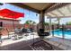 Covered patio featuring an egg chair, outdoor seating, with a view of the pool at 20038 N 38Th Ln, Glendale, AZ 85308
