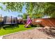 Backyard playground with trampoline, slide, swingset, and outdoor activities in Gathering-friendly area at 20038 N 38Th Ln, Glendale, AZ 85308