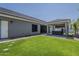 Well-manicured backyard with a covered hot tub and lush green grass at 20452 E Appaloosa Dr, Queen Creek, AZ 85142